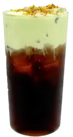 Layered iced coffee in a tall glass with dark coffee at the bottom, pale green cream on top, topped with whipped cream and crushed nuts.