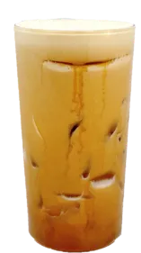 Tall glass of iced coffee with milk and visible ice cubes in a clear glass, creamy brown color